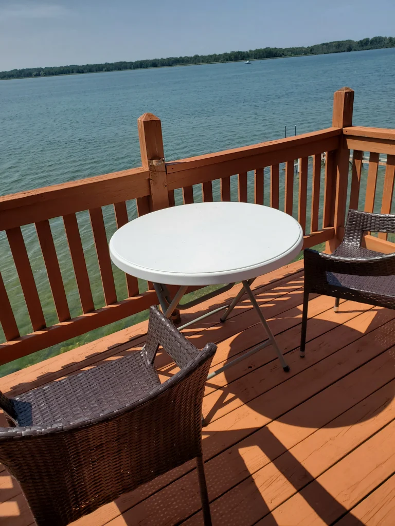 Furnished wooden balcony overlooking Cayuga Lake.