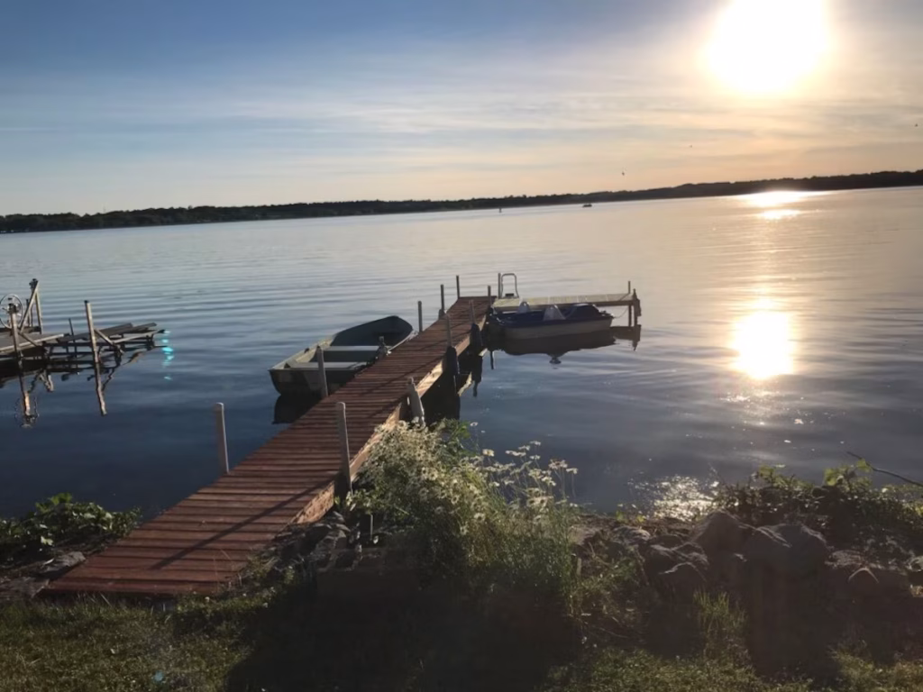 View of the dock and a sunset over Cayuga Lake.